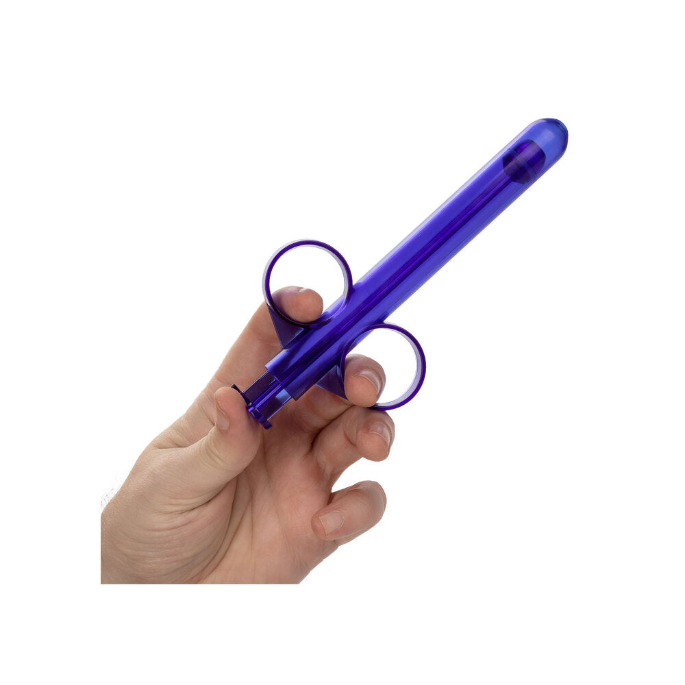 A person holding the California Exotic Admiral Lube Applicator