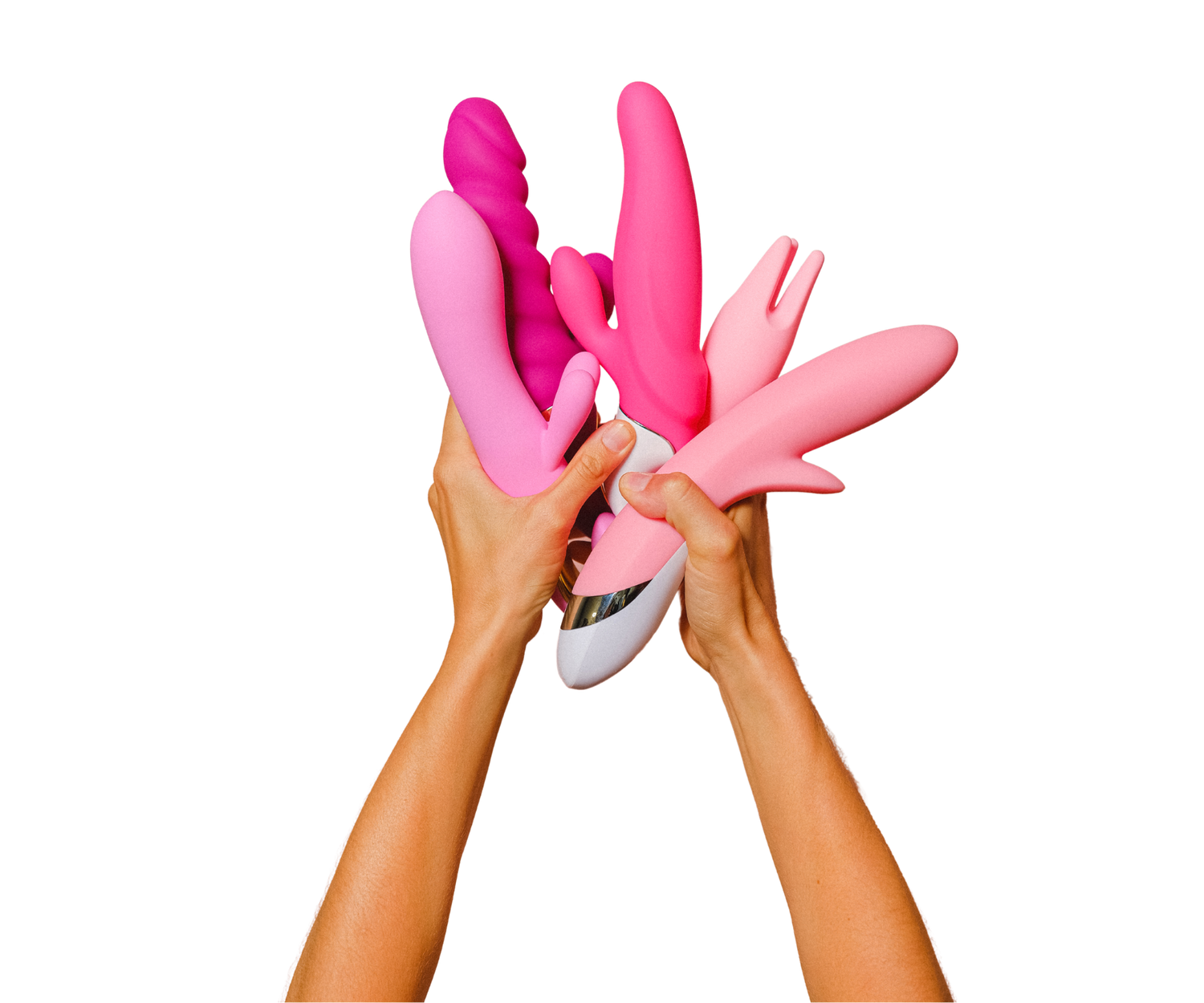 A womans hands holding up various pink sex toys