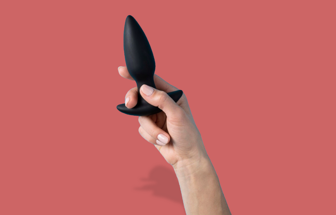 Hand holding butt plug