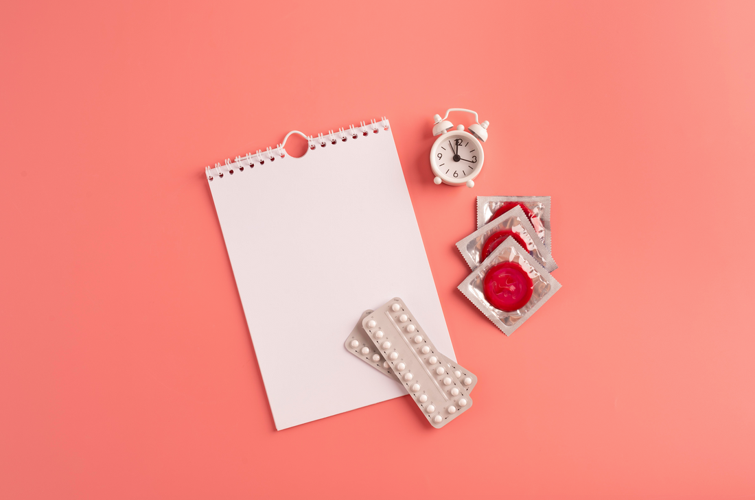 Contraceptive pills, condoms and notebook